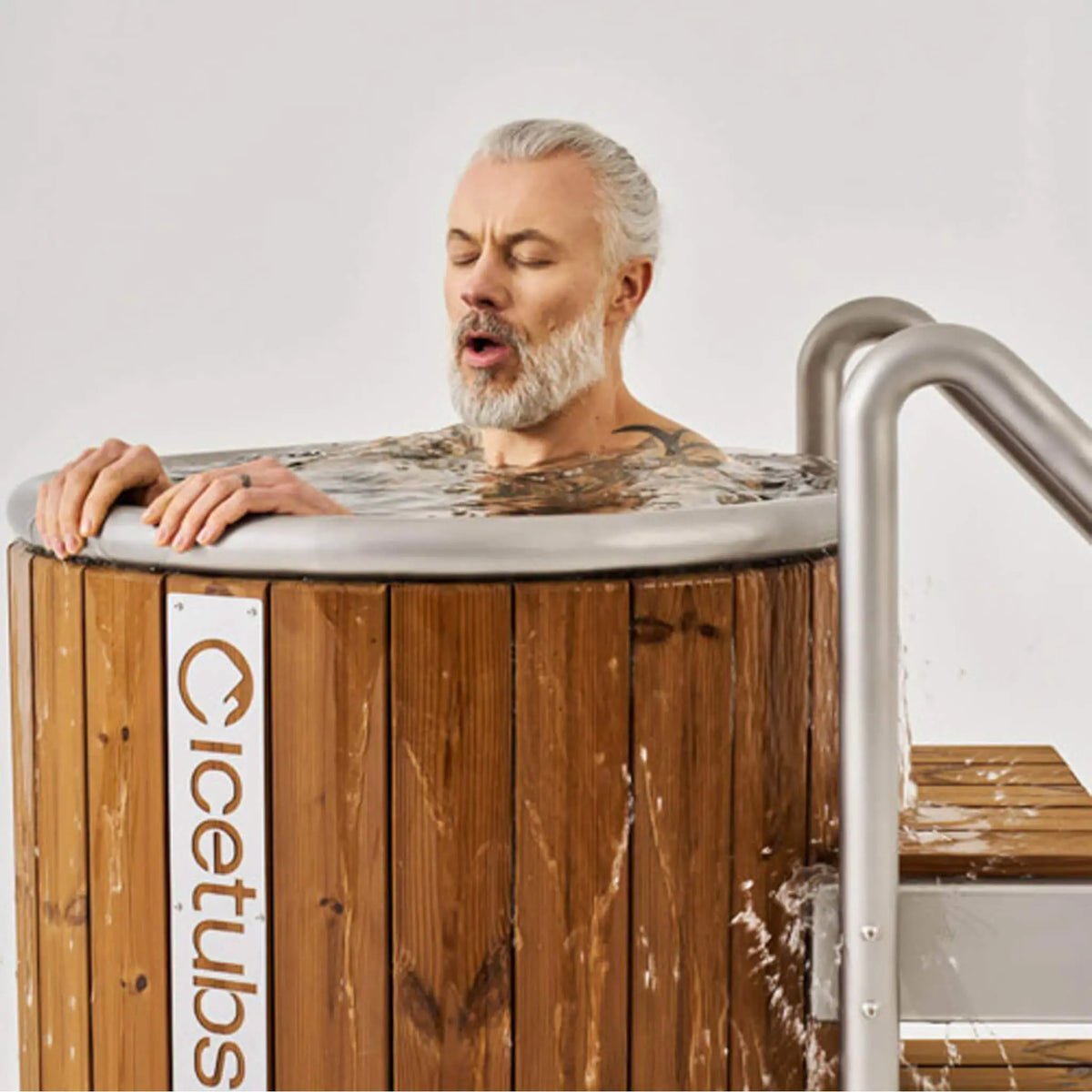 2026/08/icetubs-icebarrel-thermowood-and-fiberglass-cold-plunge-immersion-tub-lifestyle-with-man-inside.jpg